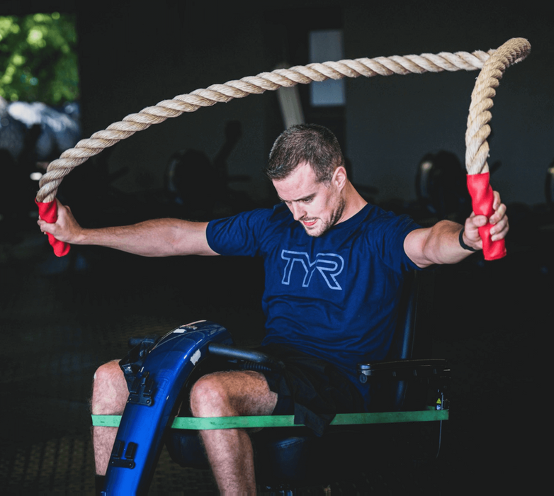 Detail of an athlete using a scooter while using the Equip Products Monster Ropes in the gym.