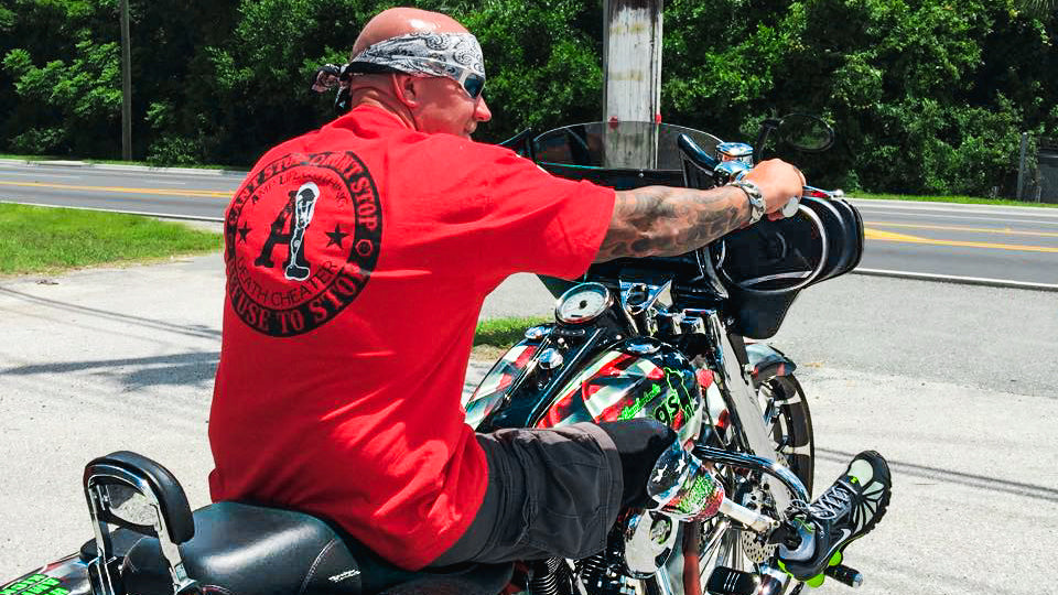 50 Legs Founder Steve Chamberland on his motorcycle wearing an Amplife® Death Cheater™ T-Shirt
