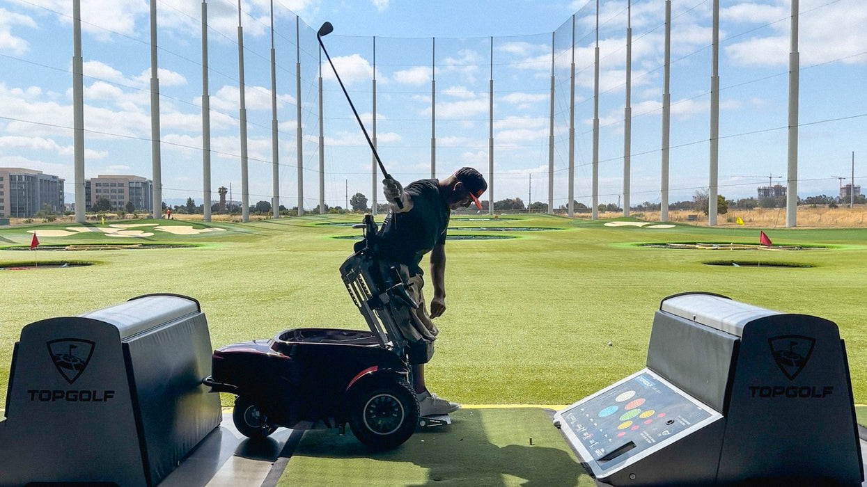 Amplife Founder Abdul Nevarez at TopGolf on an adaptive golf cart.