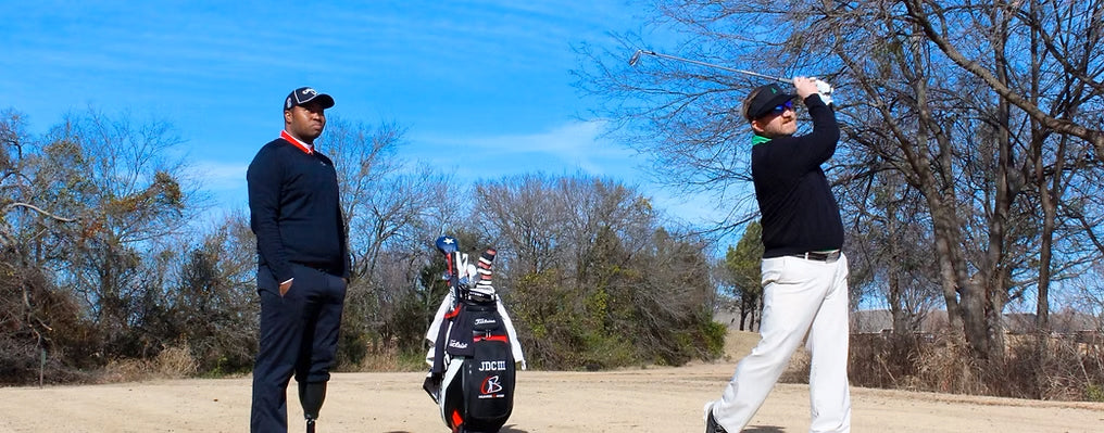 Carlos Brown coaching a business golfer.