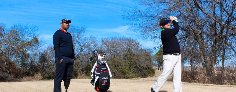 Carlos Brown coaching a business golfer.