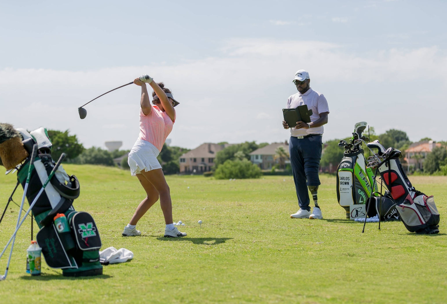 Carlos Brown filming a golfer's swing.