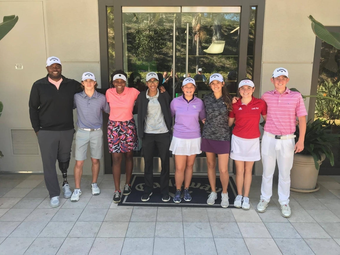 Group portrait of Carlos Brown and 7 golfers he's coached