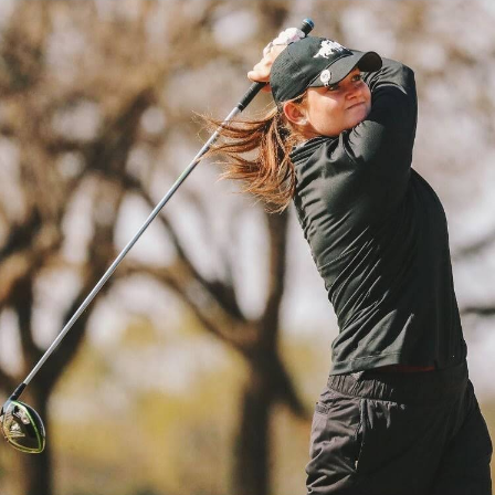 Golfer coached by Carlos Brown watching their drive shot.