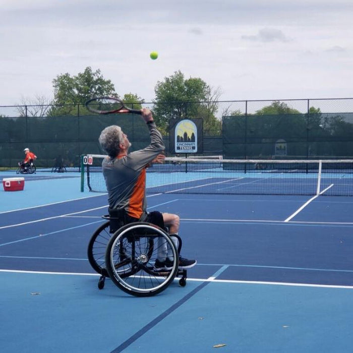 A Cincinnati Tennis Foundation advanced wheelchair tennis participant getting ready to serve.