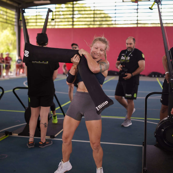 Equip Products CrossCarry Sandbag in use in competition by an athlete hoisting it over her shoulder.