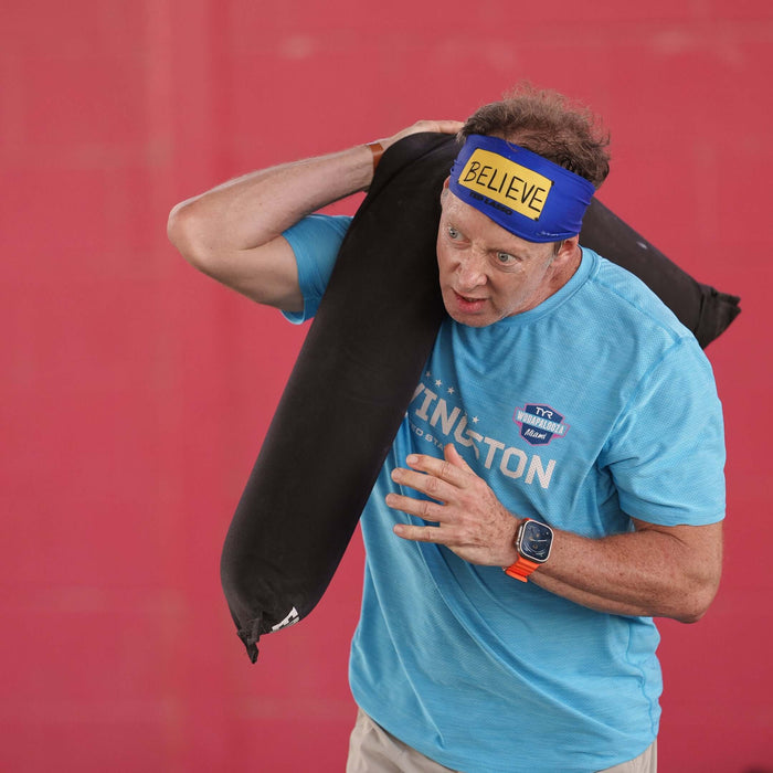 Detail pf Equip Products CrossCarry Sandbag in use in a competition by an athlete on their shoulder.