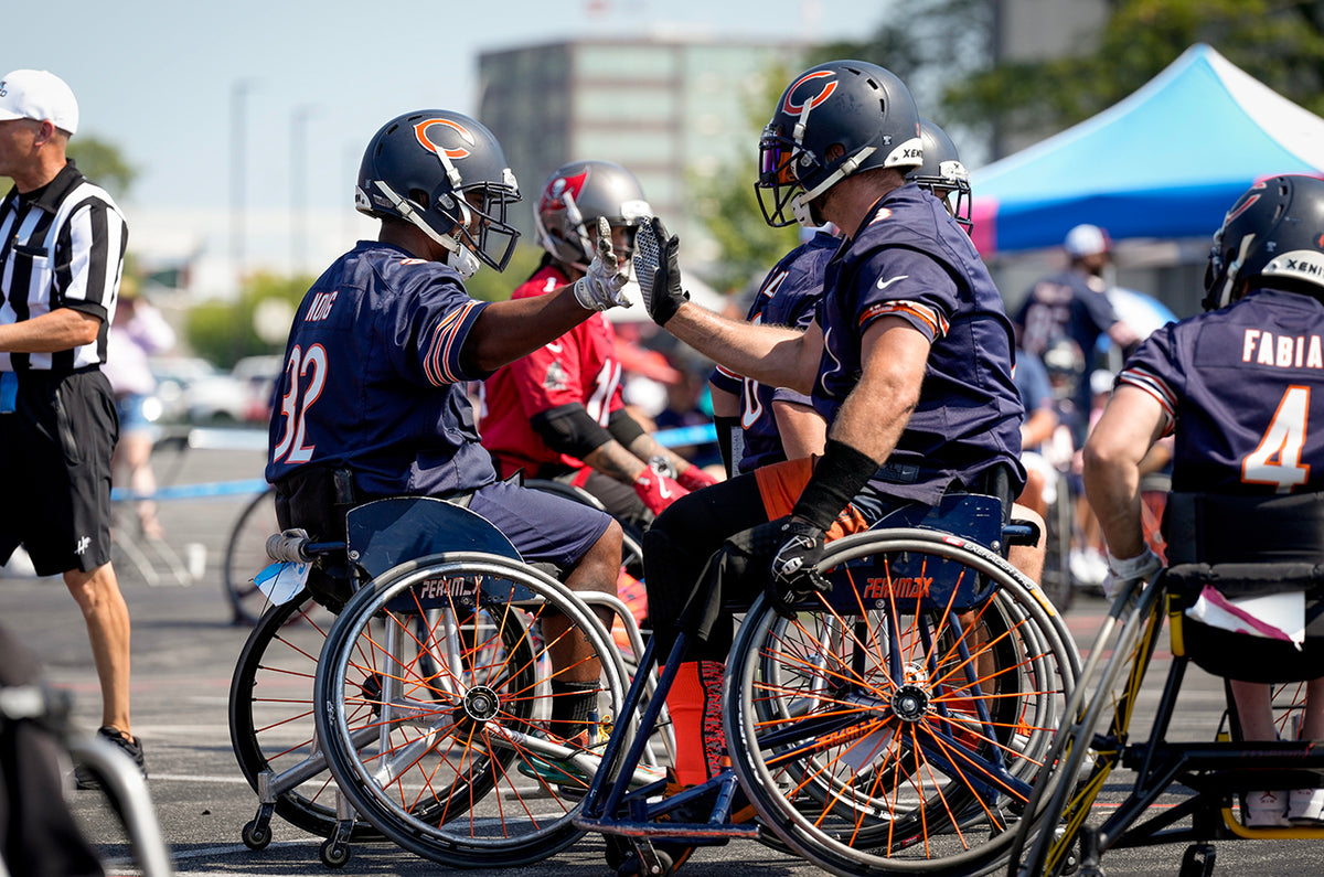 GLASA Chicago Bears Wheelchair Football players high fiving each other during a game.