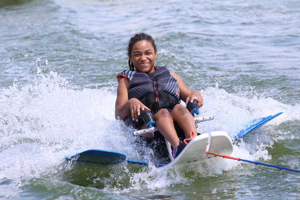 GLASA athlete waterskiing in a seated waterski.