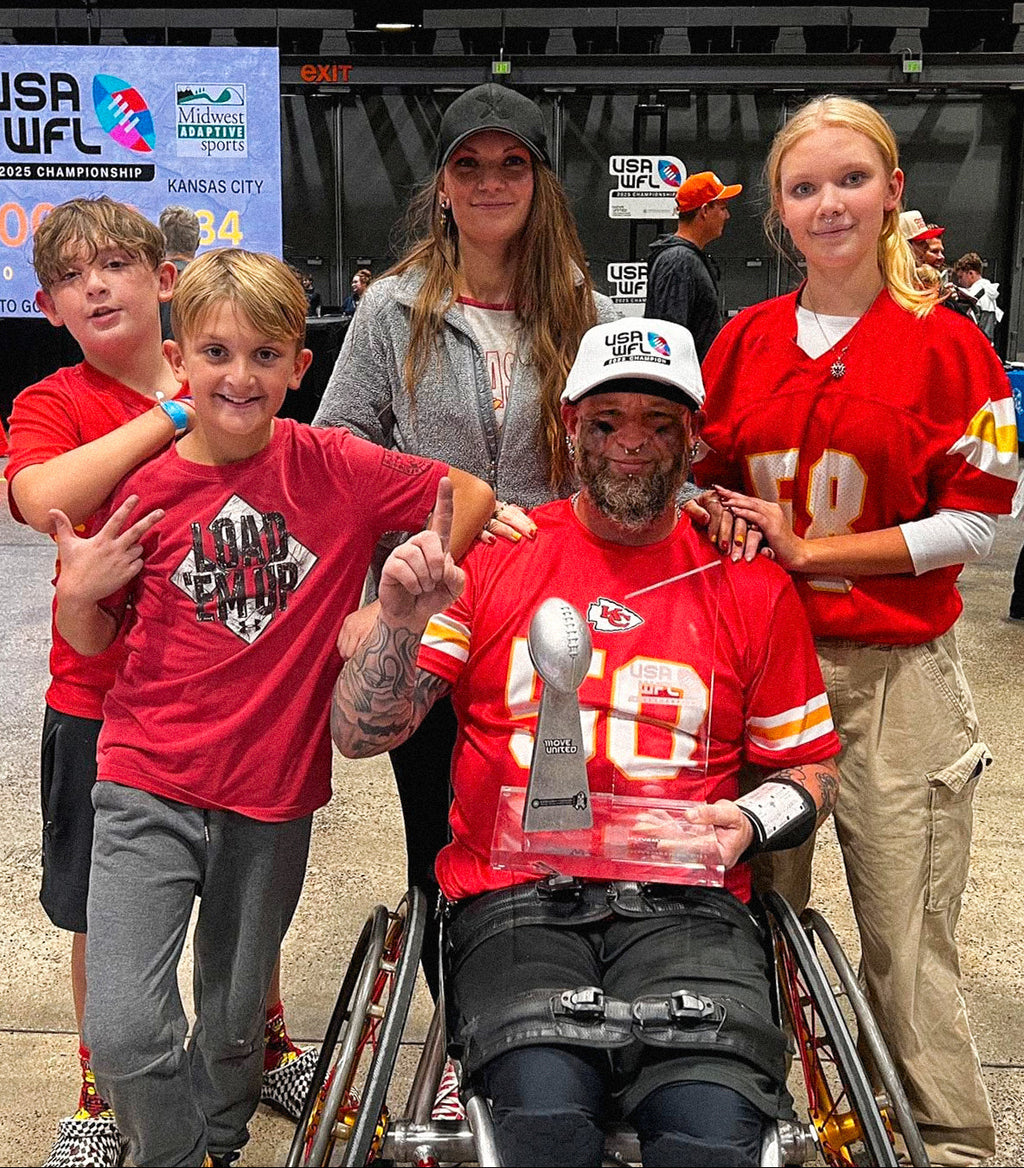 Group portrait of Team Amplife® Ambassador Jason Loftiss and his family at the 2025 USA Wheelchair Football League Championships, as he holds the championship trophy