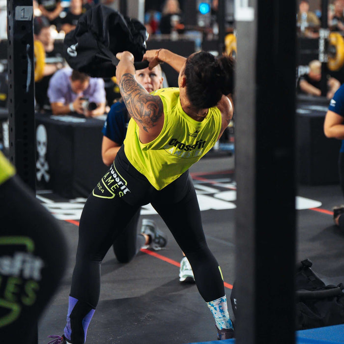 Equip Products Strongman Throw Bag being thrown in competition by an athlete with a referee watching.
