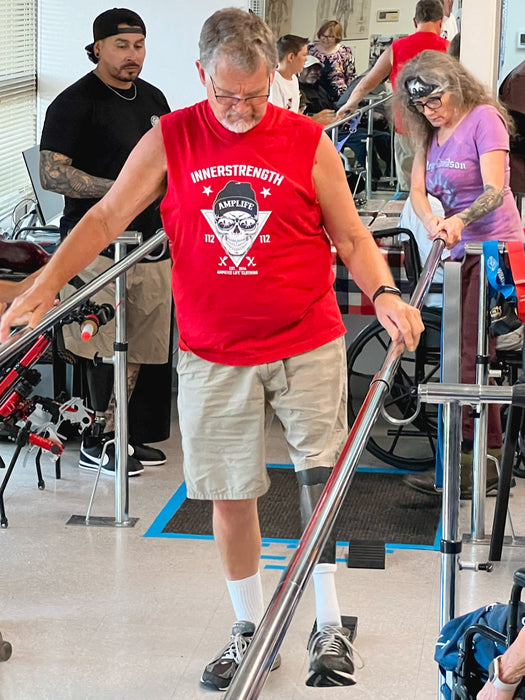 Prosthetic Solutions patient practicing walking in between walking bars.
