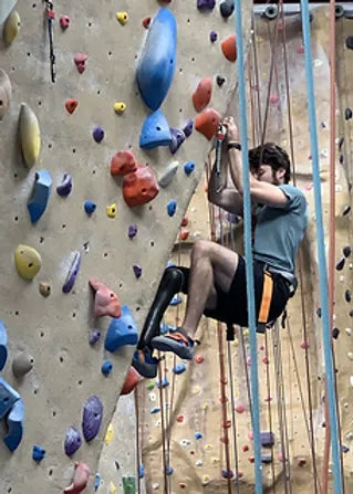Prosthetic Solutions client climbing a rock wall.