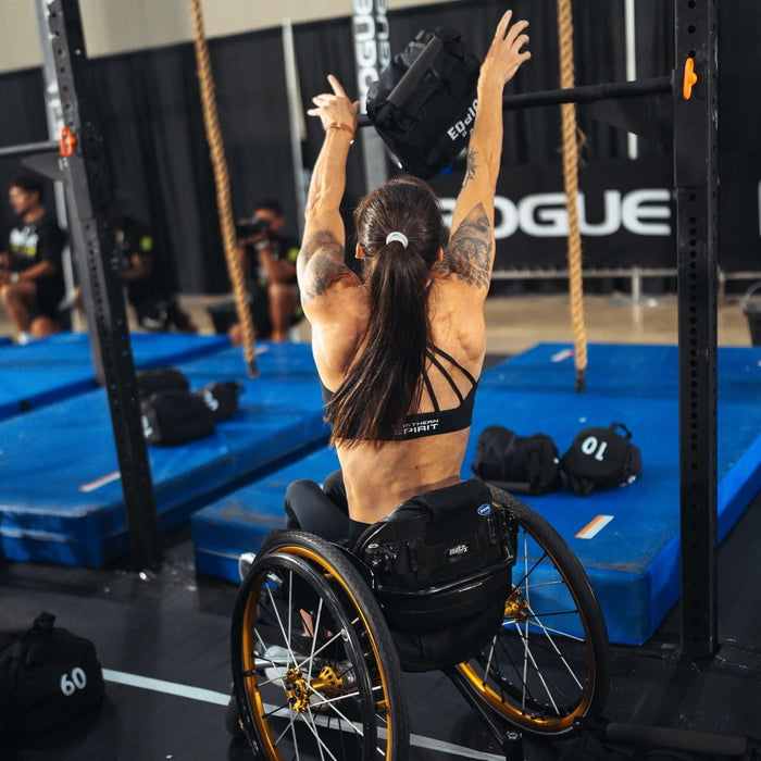 Equip Products Strongman Throw Bag being thrown in competition by an athlete using a wheelchair.