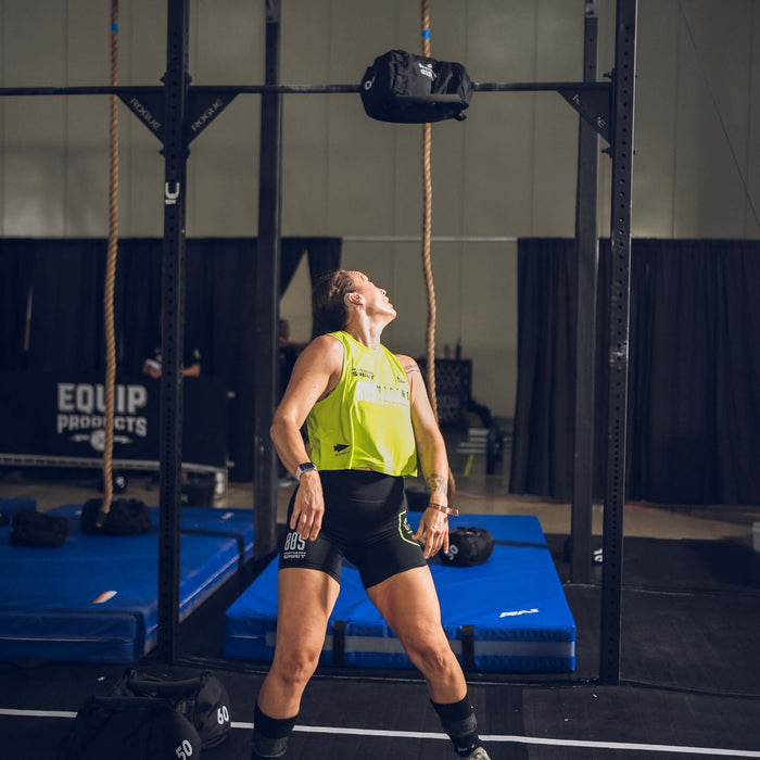 Equip Products Strongman Throw Bag being thrown in competition by an athlete watching it go above the bar.