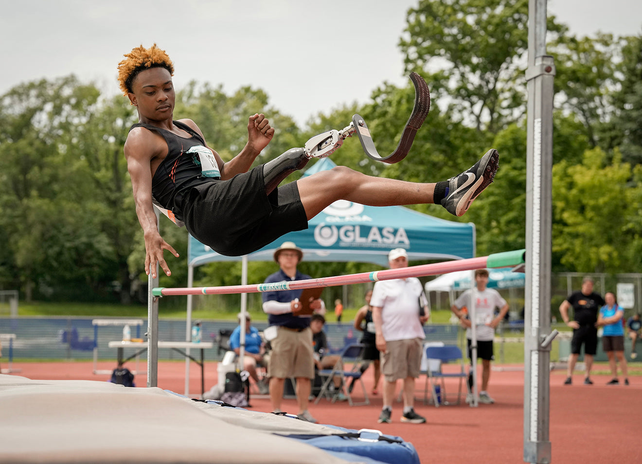 GLASA athlete clearing a high jump bar in a competition.