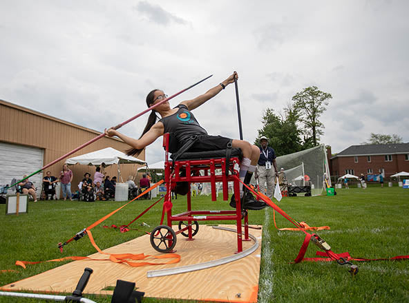GLASA athlete clearing a high jump bar in a competition.
