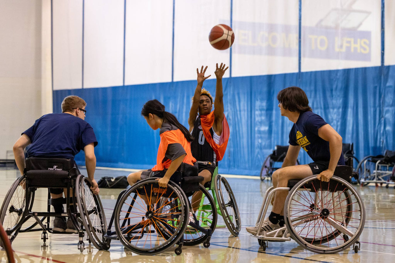 GLASA Athlete shooting a basketball while playing a wheelchair basketball game.