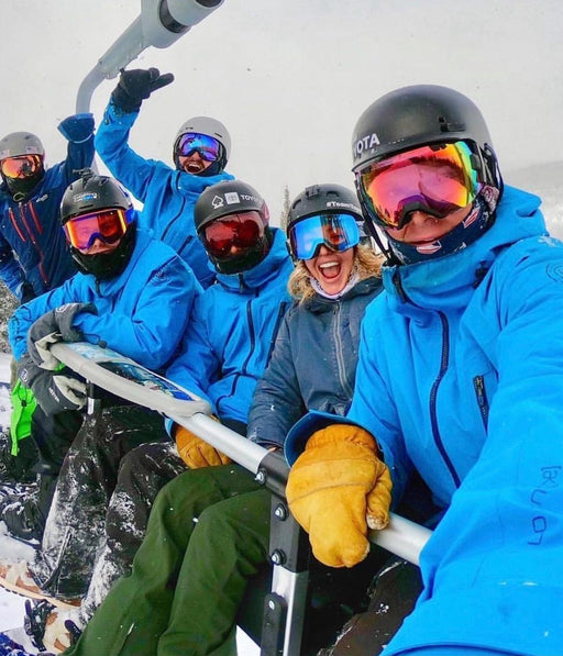 Group selfie of Adaptive Action Sports snowboarders on a ski lift.