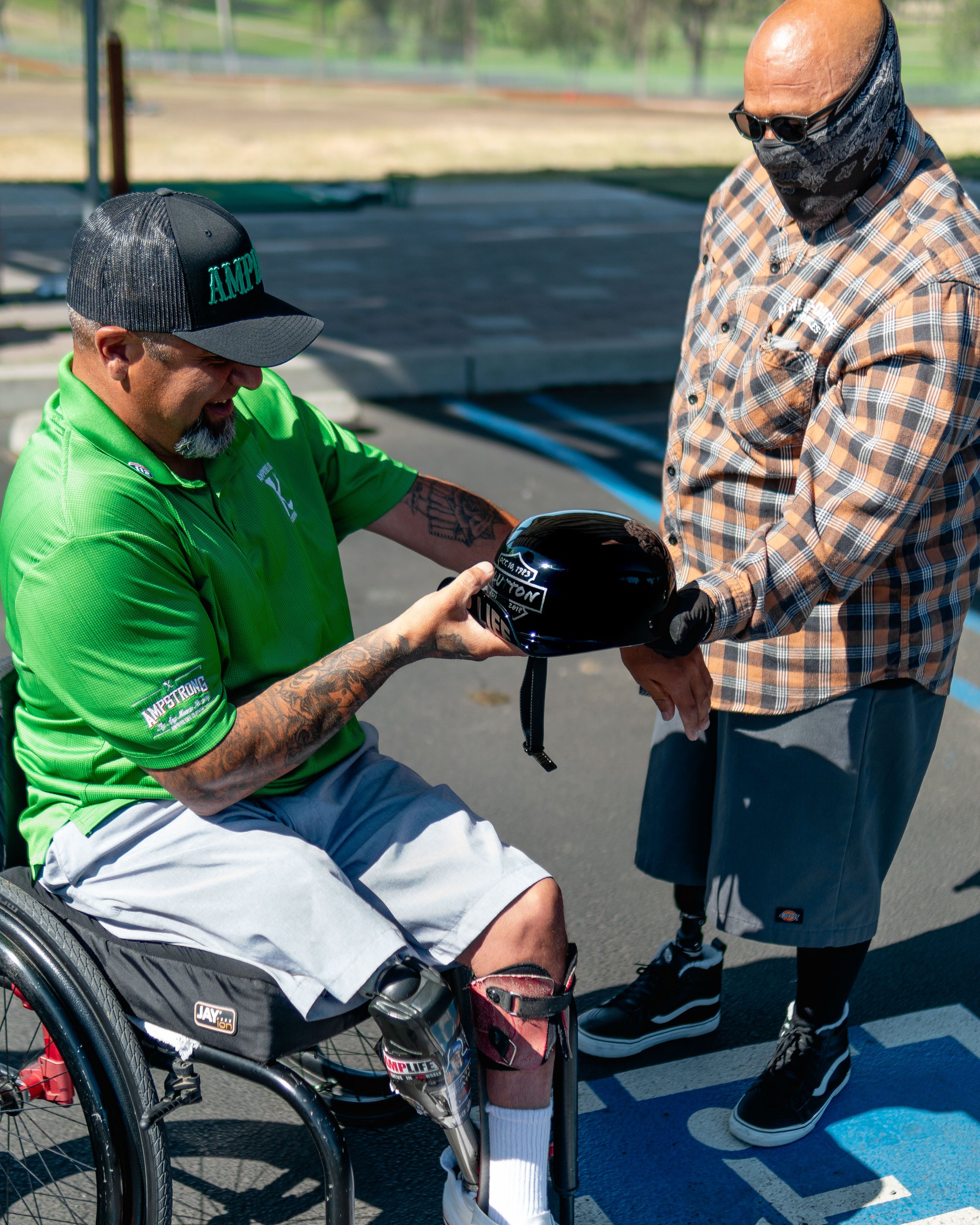 Team Amplife® Ambassador Steven Hill showing his Amplife® motorcycle helmet to  Amplife® Foundation & Amplife® Founder Abdul Nevarez