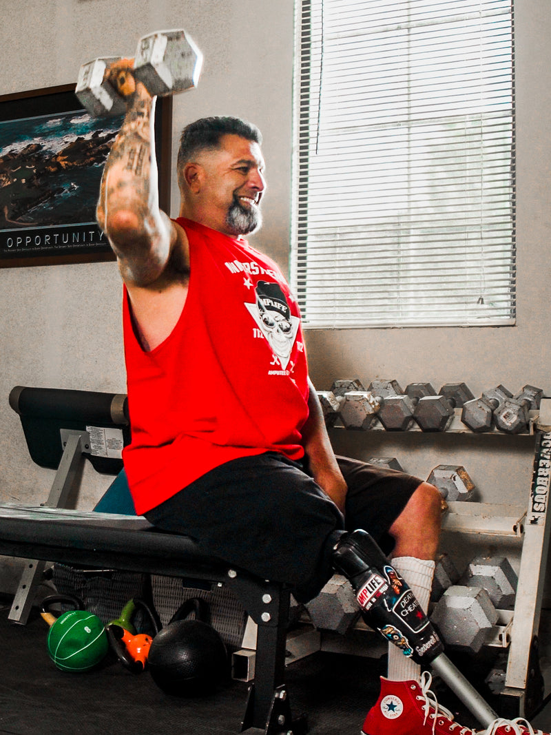 Amplife® Foundation & Amplife® Founder Abdul Nevarez shoulder pressing in his home gym