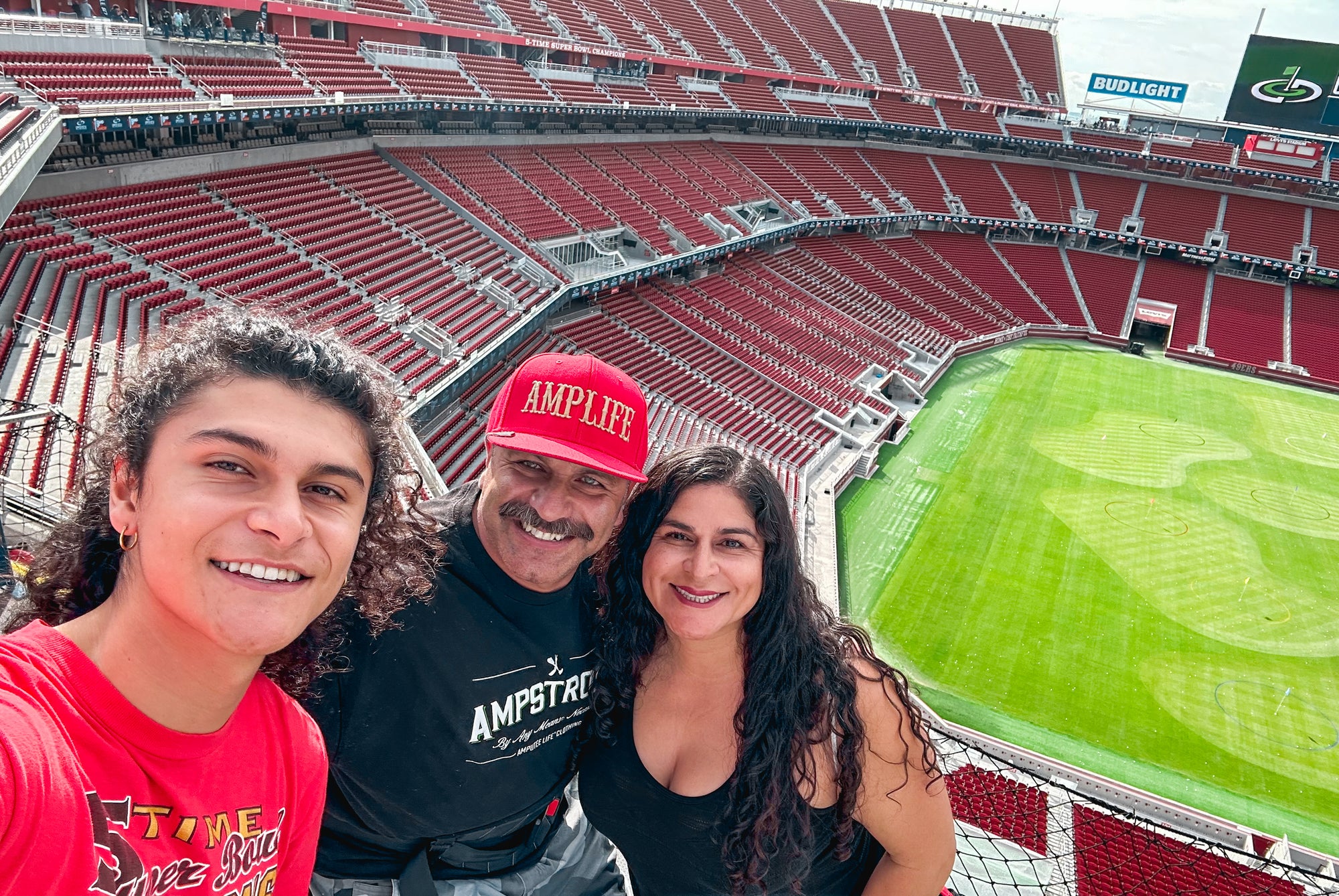 Group photo of Amplife® Foundation & Amplife® Co-Founders Abdul Nevarez, Priscilla Nevarez & Amplife® Foundation Co-Founder Armando Nevarez golfing from the decks in the 49ers stadium after the Nevarez v Forty Niners Football Company, LLC Settlement