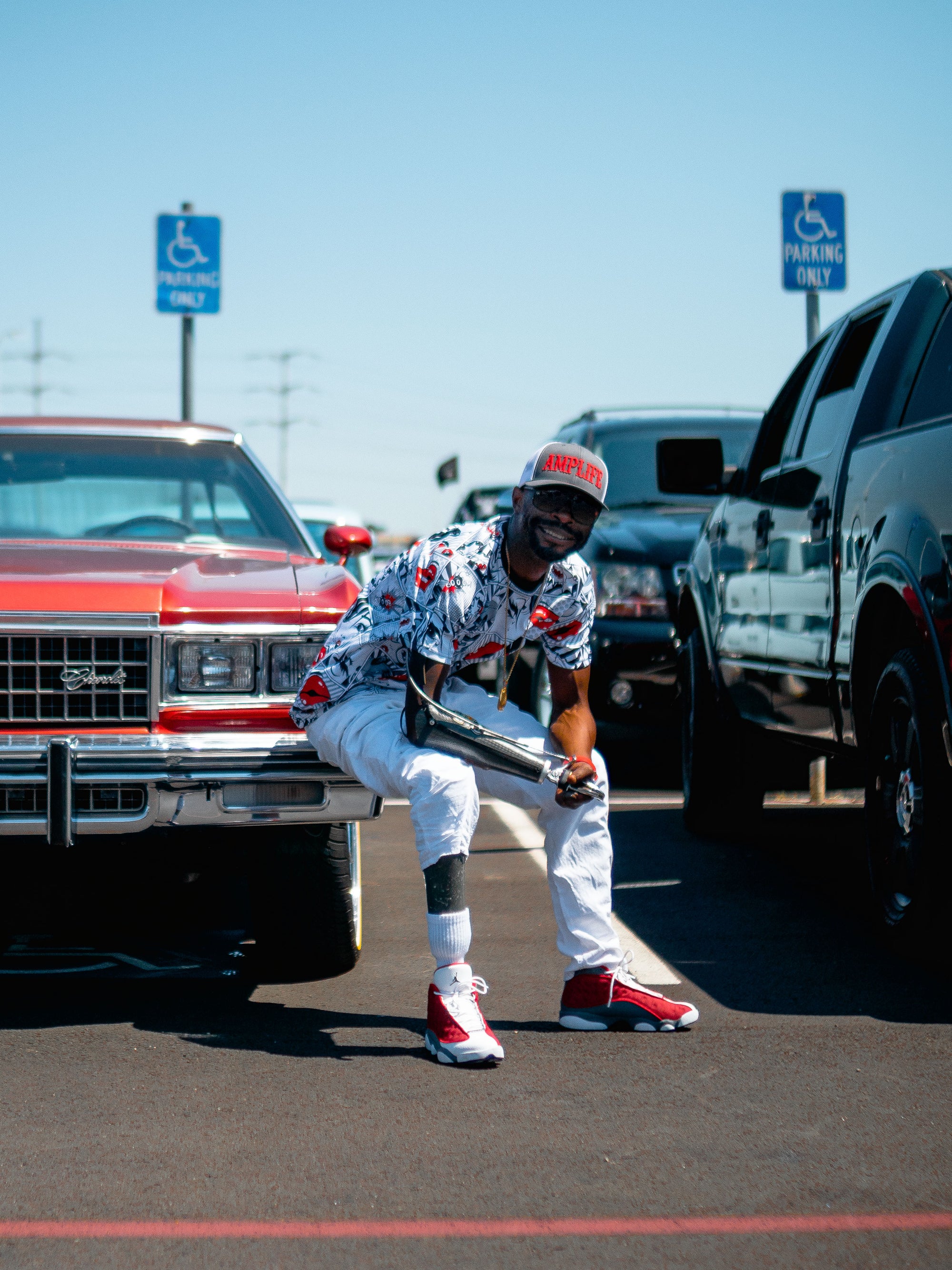 Portrait of Amplife® Supporter sitting on their 1970's Chevy