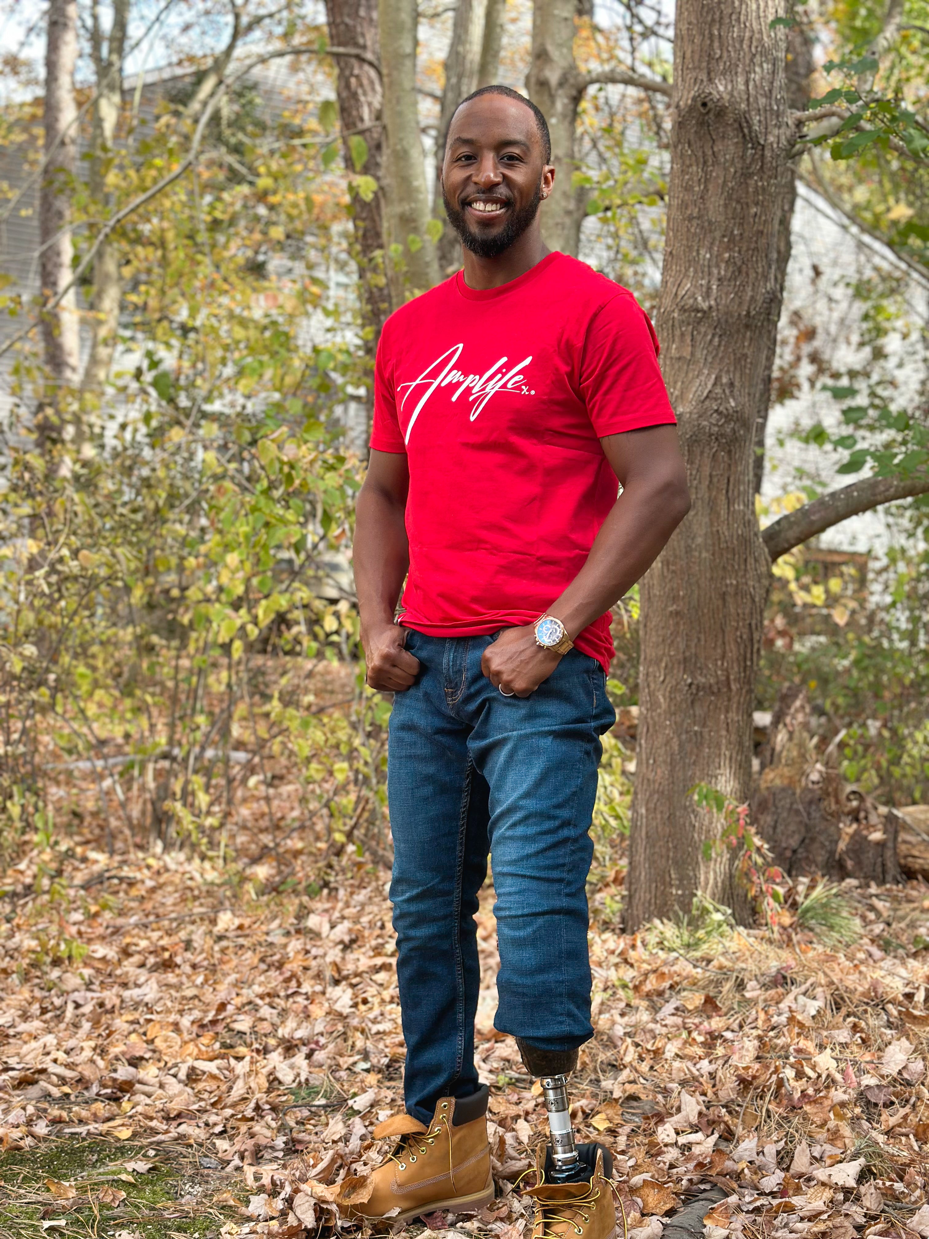 Team Amplife® Ambassador Michael Braxton Jr. wearing the Amplife® Signature T-Shirt in the woods