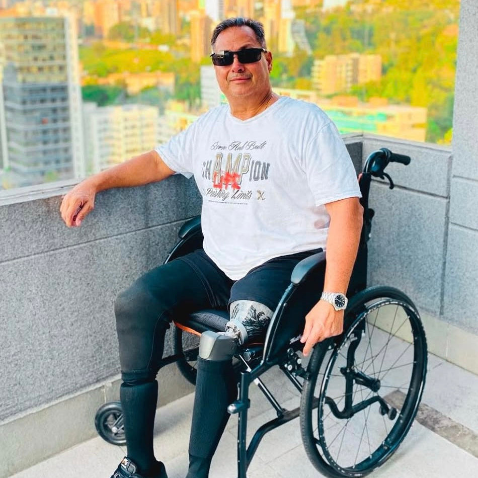 Team Amplife® Ambassador Bert Chirino on a balcony in a city and rockin’ his Amplife® while wearing the Amplife® Born and Built Champion T-Shirt