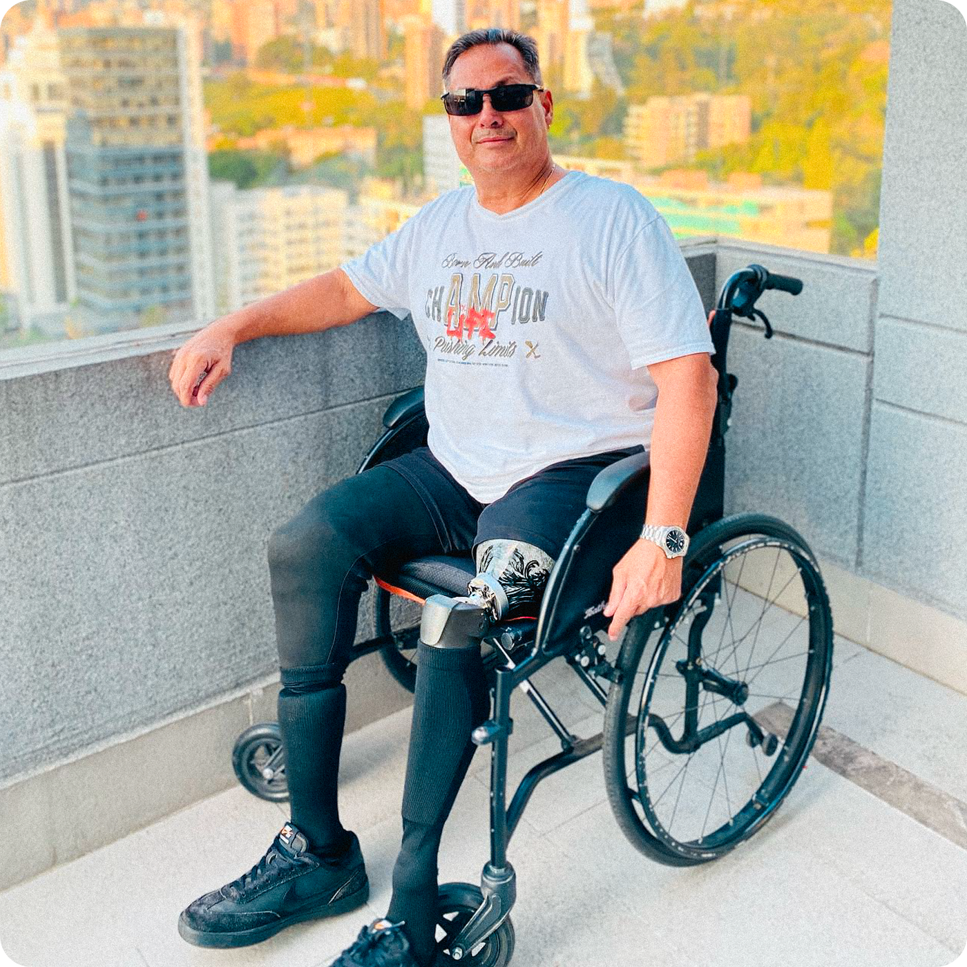 Team Amplife® Ambassador Bert Chirino on a balcony in a city and rockin’ his Amplife® while wearing the Amplife® Born and Built Champion T-Shirt