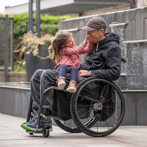 Billy Price interacting with his daughter while she sits on his lap and both of them wearing BILLY Footwear