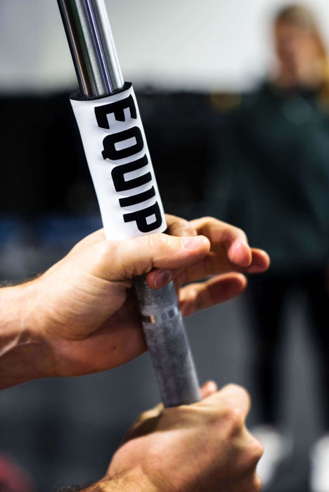 Detail of Equip Products Barbell Markers for Visually Impaired in use on a barbell with an athlete holding on the barbell next to the marker.