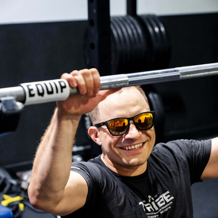 Equip Products Barbell Markers for Visually Impaired in use by an athlete with visual impairment.