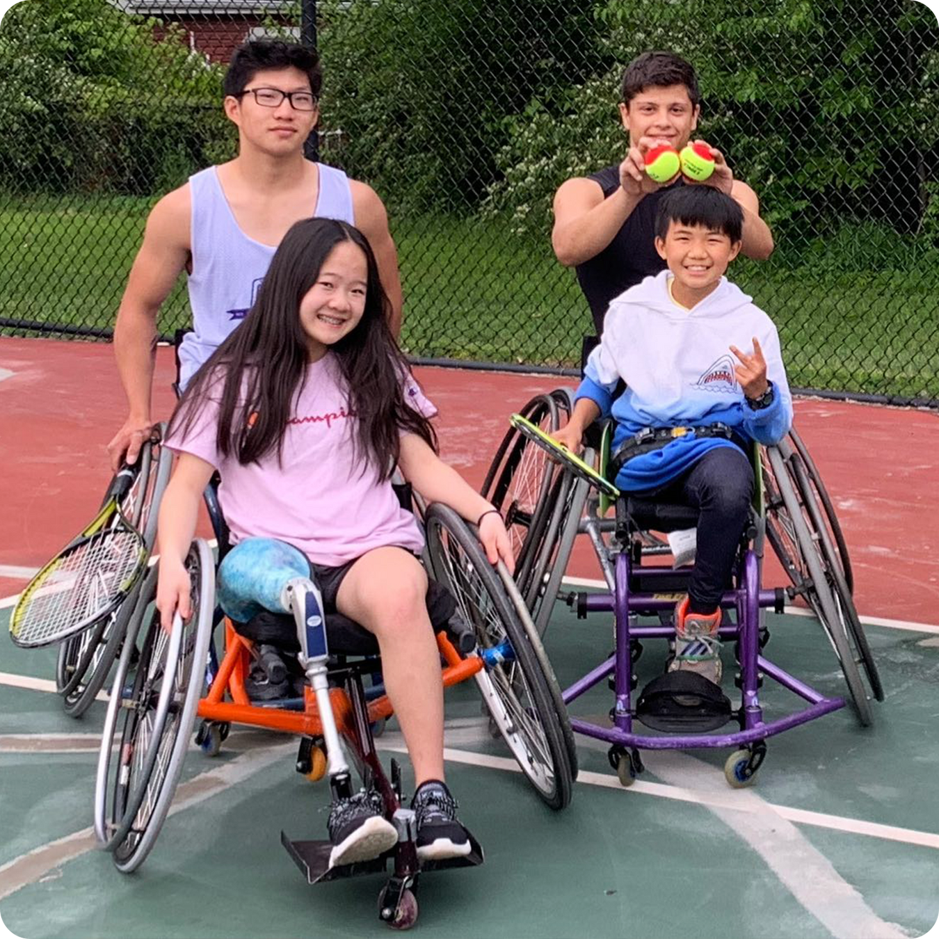 Group portrait of Cincinnati Tennis Foundation youth players on a tennis court using wheelchairs