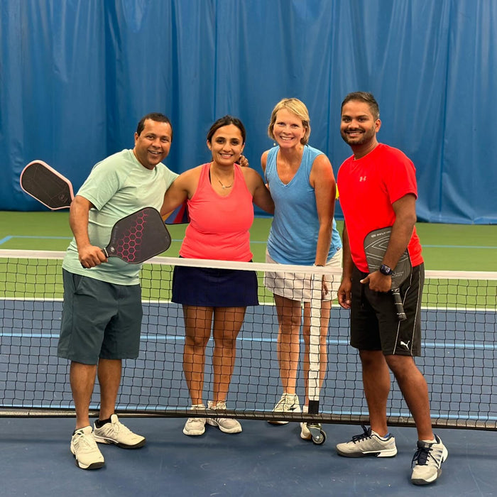 Portrait of four Cincinnati Tennis Foundation Championship wheelchair and para-standing competitors on the court with their pickleball paddles.