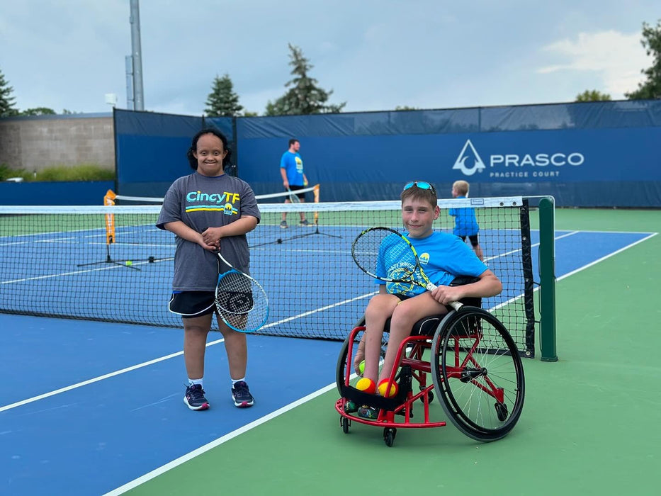Two children on a tennis court.
