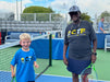 Woman and child from Cincinnati Tennis Foundation on a tennis court.