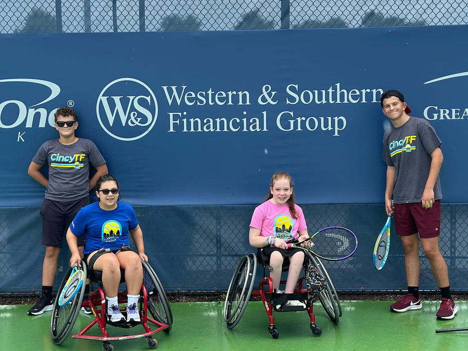 Four people from Cincinnati Tennis Foundation on a tennis court.