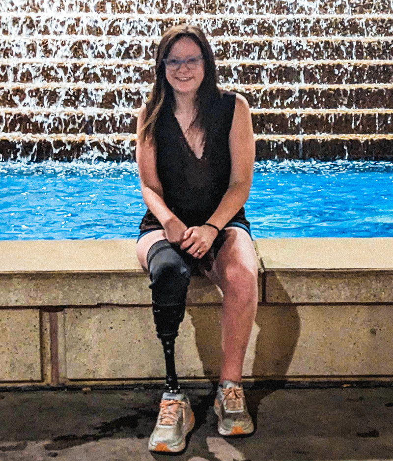 Team Amplife® Ambassador Danielle Miller Williams sitting by a water fountain