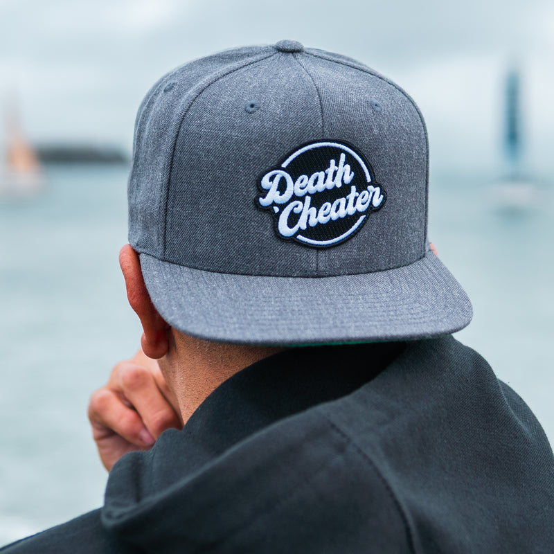 Amplife® Founder Abdul Nevarez wearing the Death Cheater® Halo Flat Bill Snapback while looking at Alcatraz Island