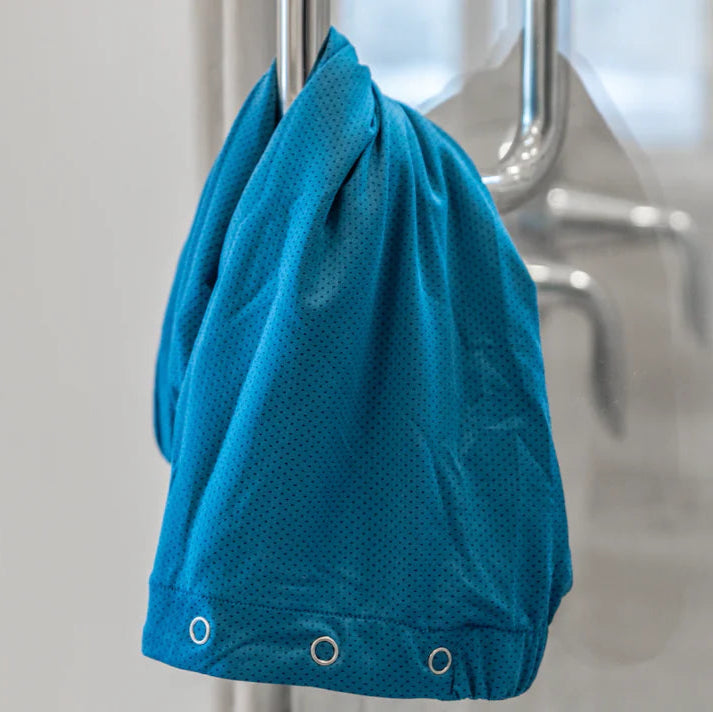 Dignity Bath & Spa The Wrap hanging on a metal bathroom shower handle