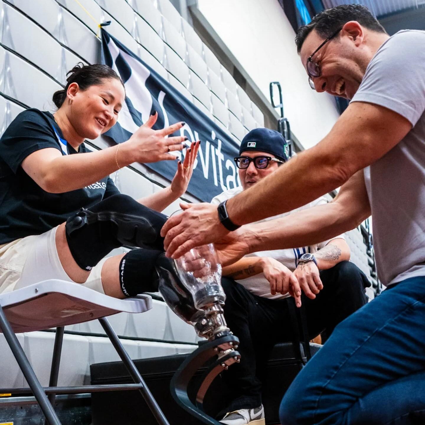 Person receiving a prosthetic leg fitting from a professional in an urban setting.