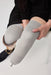 A close-up of a person with a liner on with the Ethnocare Underlay Transtibial Closed Prosthetic Sweat Management Device underneath