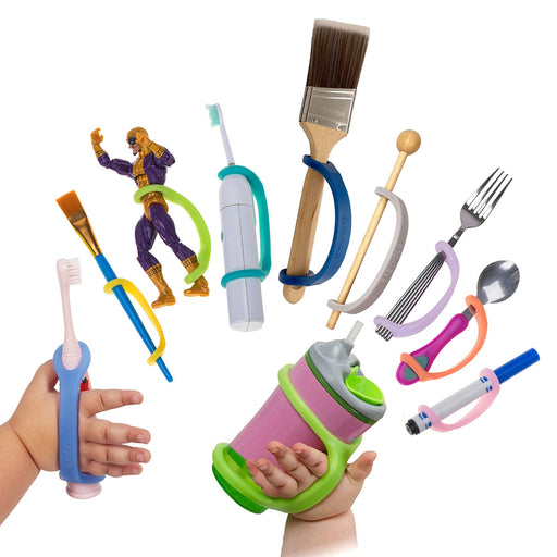 Assorted children's utensils and toys with an EaZyHold Grip Aid on a white background