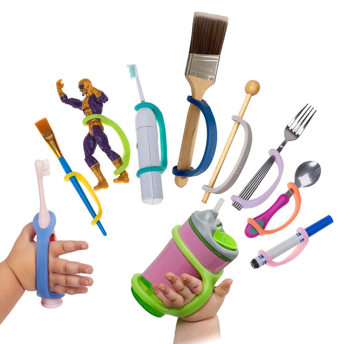 Assorted children's utensils and toys with an EaZyHold Grip Aid on a white background