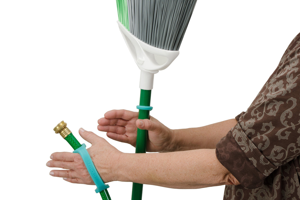 Person holding a broom and hose with an aqua EaZyHold Grip Aid