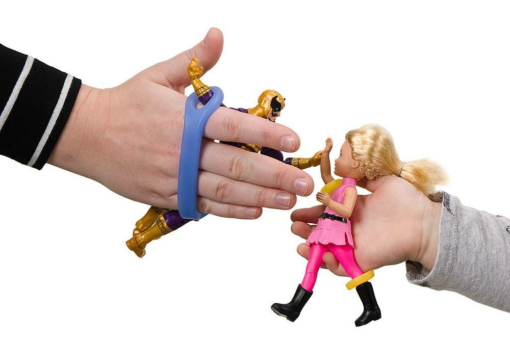 Two hands holding toy figures with an EaZyHold Grip Aid on a white background