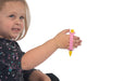 Child holding a yellow crayon with a pink EaZyHold Grid Aid against a white background