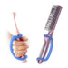Purple comb and hand holding a pink toothbrush with a blue EaZyHold Grid Aid on a white background