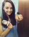 Woman holding a makeup brush with an orange EaZyHold Grid Aid and compact powder
